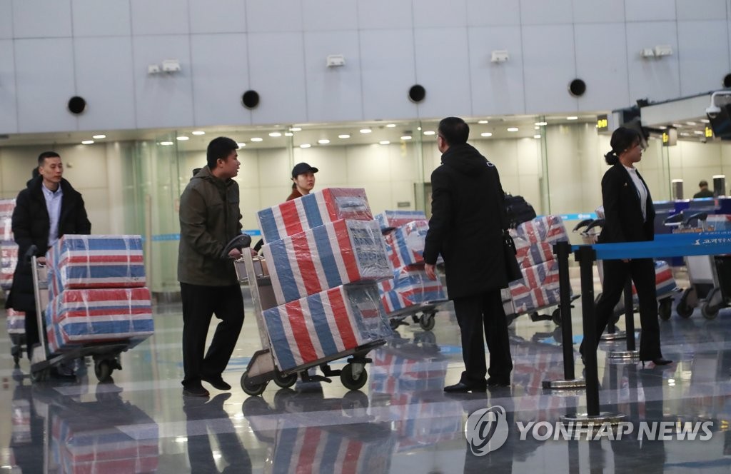This photo, taken at Beijing international airport on Dec. 21, 2019, shows people presumed to be North Korean workers returning home, one day ahead of the U.N.-imposed deadline for member states to repatriate all North Korean laborers home. (Yonhap)