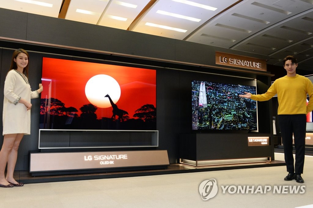 This photo provided by LG Electronics Inc. on Jan. 3, 2020, shows models introducing the company's Signature OLED 8K TVs. (PHOTO NOT FOR SALE) (Yonhap)