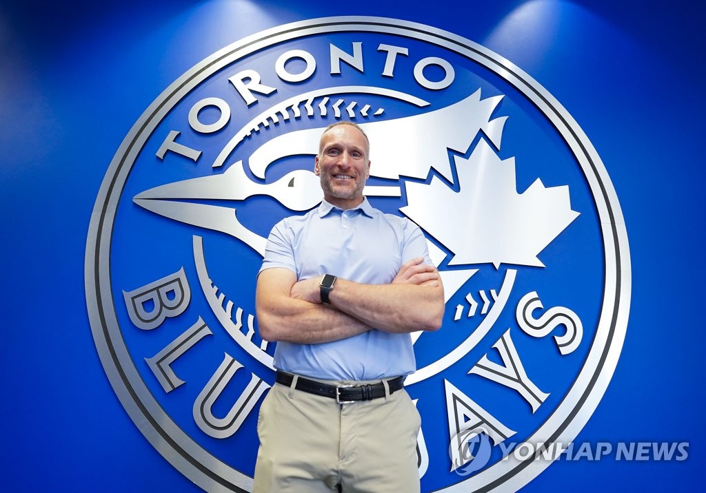 Toronto Blue Jays CEO and President Mark Shapiro poses for a photo in front of the club's logo at TD Ballpark in Dunedin, Florida, on Feb. 17, 2020. (Yonhap)