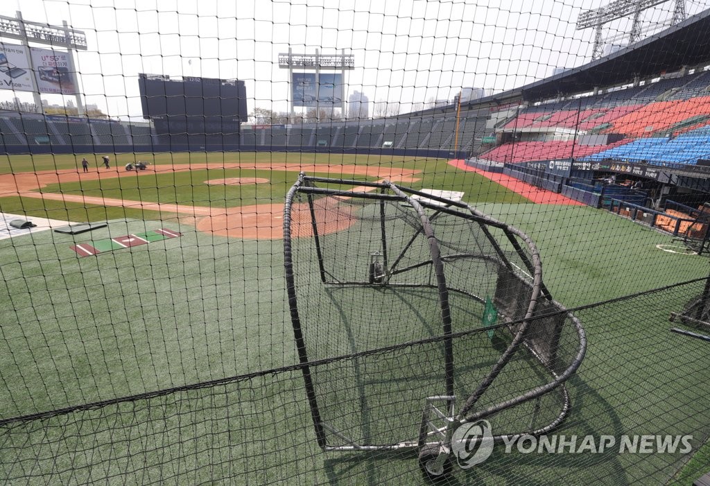 A grounds crew at Jamsil Stadium in Seoul works on the field on April 1, 2020, following the cancellation of the Doosan Bears' practice. (Yonhap)