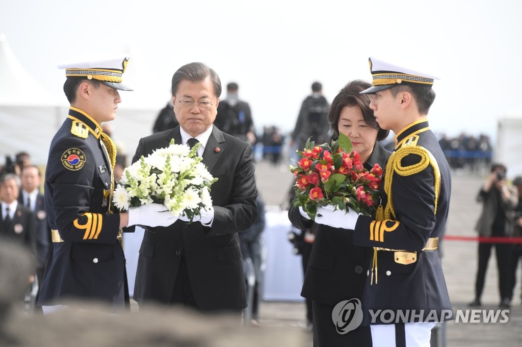 President Moon Jae-in (2nd from L) and first lady Kim Jung-sook lay flowers in front of the altar set up at the Jeju April 3 Peace Park, located on the southern island of Jeju, on April 3, 2020. (Yonhap)