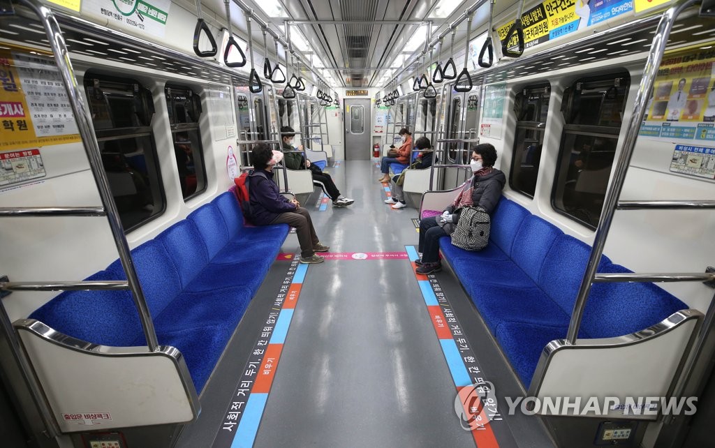 This file photo shows subway users in Daegu seated apart amid the social distancing campaign against the coronavirus. (Yonhap)