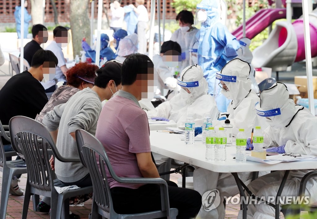 Visitors are tested for the new coronavirus at a makeshift clinic in Incheon, west of Seoul, on June 3, 2020.