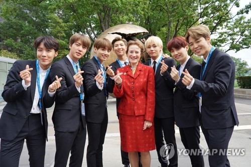 This photo, provided by UNICEF Korea, shows global K-pop sensation BTS posing for a photo with UNICEF Executive Director Henrietta Fore in 2018, when the group conveyed a "Love Myself" message to the world at the U.N. general assembly. On June 22, 2020, UNICEF awarded BTS' "Love Myself" campaign an Inspire Award in the Integrated Campaigns and Events category. The campaign, which began in 2017, is aimed at ending violence against children and young people across the globe. (PHOTO NOT FOR SALE) (Yonhap)