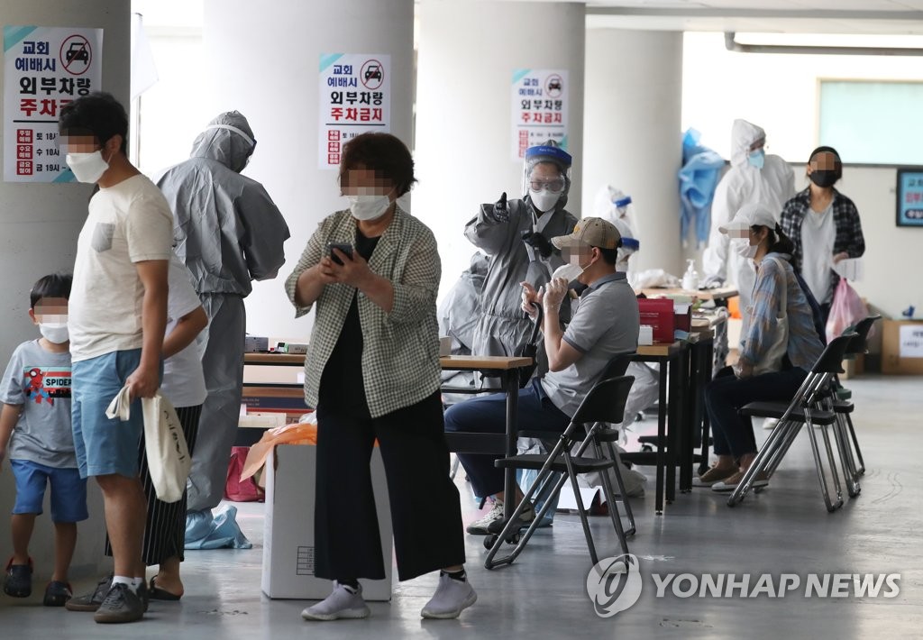 Worshipers at a church in Seoul's southern Gwanak Ward wait to receive new coronavirus tests at a temporary screening center set up in the church on June 26, 2020, as at least 12 cases tied to the church have been reported. (Yonhap)
