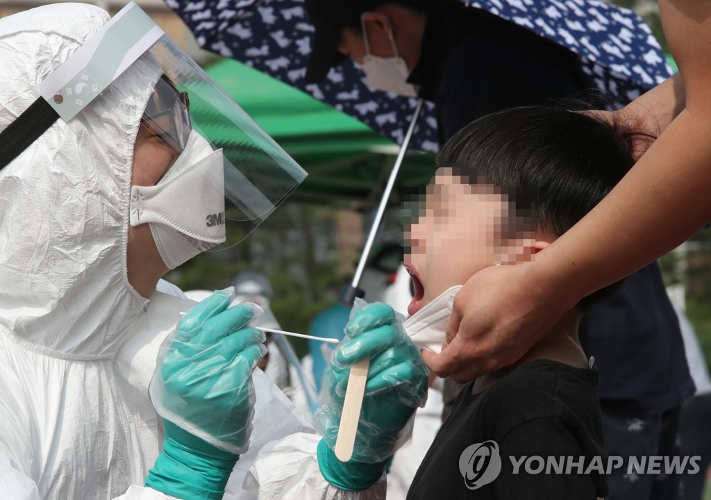 A student receives a new coronavirus test at an elementary school in Daejeon, 164 kilometers south of Seoul, on July 2, 2020. (Yonhap)