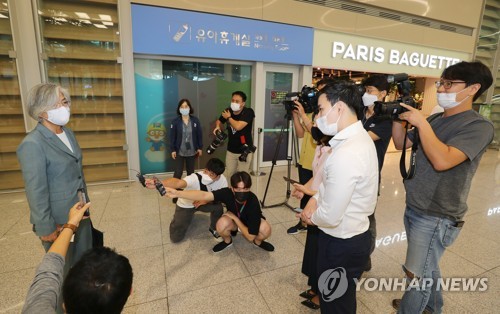 仁川空港で報道陣の質問に答える康長官＝１１日、仁川（聯合ニュース）