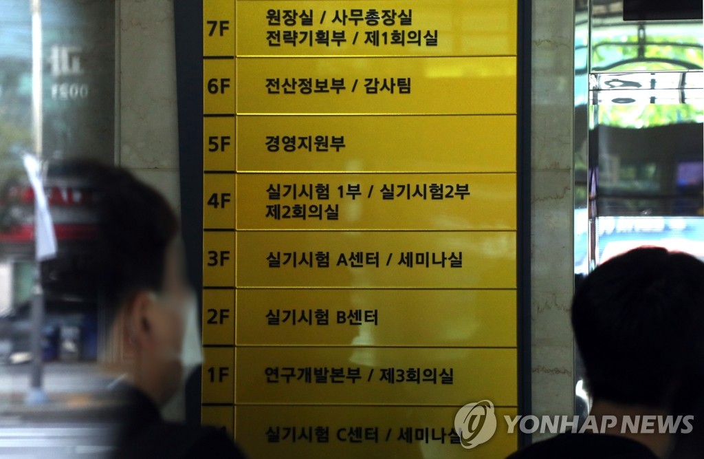 Officials enter a building in eastern Seoul on the second day of a state medical licensing exam on Sept. 9, 2020. (Yonhap)