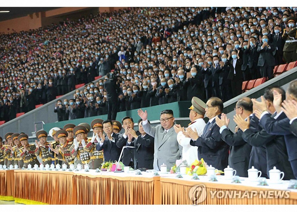 North Korean leader Kim Jong-un (7th from R) waves during a mass gymnastics and artistic performance held at the May Day Stadium in Pyongyang on Oct. 11, 2020, in celebration of the 75th founding anniversary of the ruling Workers' Party, in this photo provided by the Rodong Sinmun on Oct. 12. (For Use Only in the Republic of Korea. No Redistribution) (Yonhap)