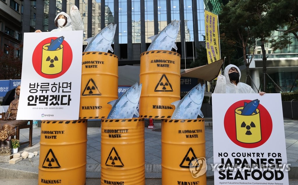 Activists stage a campaign near the Japanese Embassy in Seoul calling for the boycott of Japanese seafood in protest against Tokyo's plan to discharge into the sea radioactive water from its wrecked Fukushima nuclear power plant, in this photo taken Nov. 9, 2020. (Yonhap)