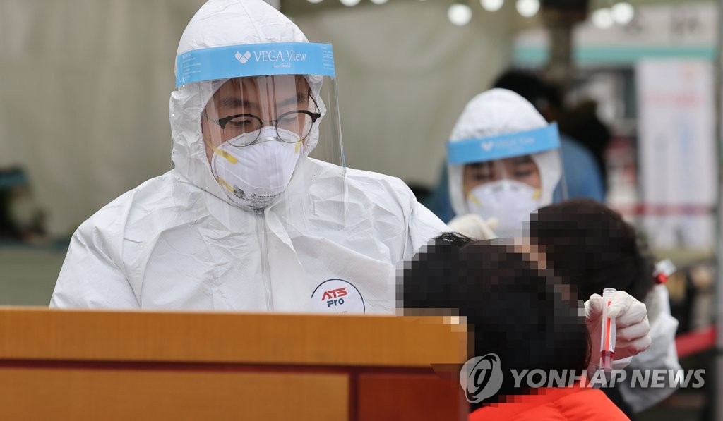 Medical staffers prepare to carry out COVID-19 tests at a makeshift clinic in central Seoul on Dec. 18, 2020. (Yonhap)