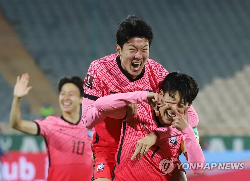 Son Heung-min of South Korea (R) is congratulated by teammate Hwang Ui-jo after scoring a goal against Iran during the teams' Group A match in the final Asian qualifying round for the 2022 FIFA World Cup at Azadi Stadium in Tehran on Oct. 12, 2021. (Yonhap)
