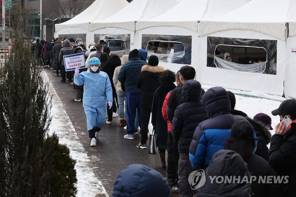 Cette photo prise le 1er février 2022 montre des gens attendant devant un centre de dépistage du Covid-19 à Séoul pour se faire tester. 