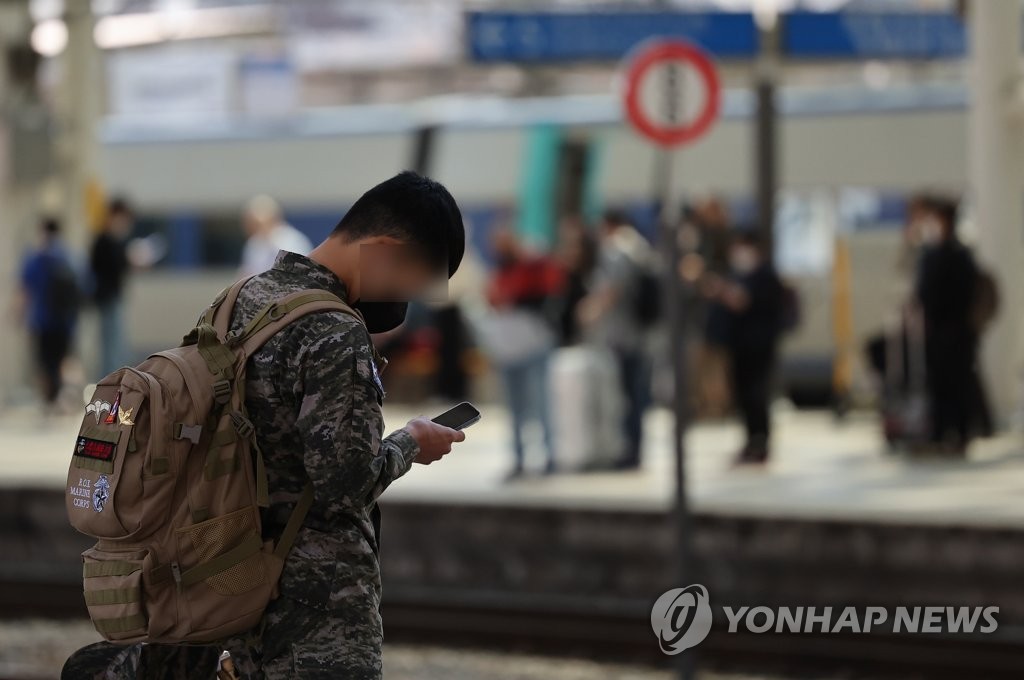 This photo taken on May 1, 2022, shows a soldier looking at his smartphone while waiting for a train at Seoul Station in central Seoul. (Yonhap)