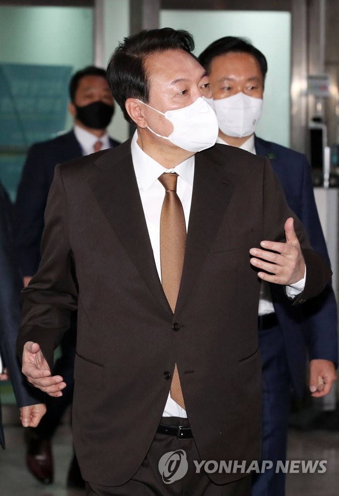 President Yoon Suk-yeol speaks to reporters as he arrives for work at the presidential office in Seoul on May 17, 2022. (Pool photo) (Yonhap)