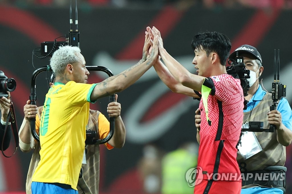 In this file photo from June 2, 2022, Son Heung-min of South Korea (R) high-fives Neymar of Brazil after Brazil's 5-1 victory in a men's football friendly match at Seoul World Cup Stadium in Seoul. (Yonhap)