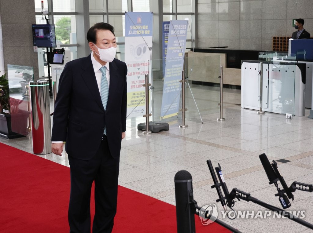 President Yoon Suk-yeol takes reporters' questions as he arrives at the presidential office in Seoul on July 21, 2022. (Yonhap)