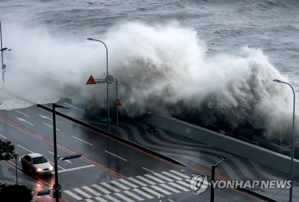 In this file photo, a wave of water engulfs a seaside road in Busan on Sept. 6, 2022, as Typhoon Hinnamnor makes landfall in South Korea. (Yonhap)