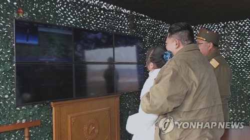 North Korean leader Kim Jong-un and his daughter watch a screen as he oversaw the test-firing of an intercontinental ballistic missile on Nov. 18, 2022, in this footage released on Nov. 20, 2022 by the North's Korean Central Television. (For Use Only in the Republic of Korea. No Redistribution) (Yonhap)