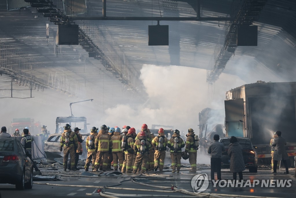 Firefighters battle a fire inside a noise-barrier tunnel on an expressway in Gwacheon, just south of Seoul, on Dec. 29, 2022. At least five people were found dead and 37 others injured, three of them seriously, in the fire that broke out at 1:49 p.m. inside the tunnel, fire authorities said. (Yonhap)