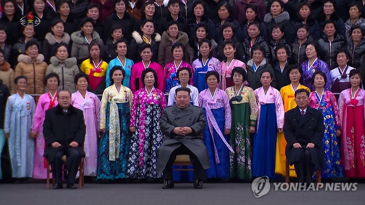 North Korean leader Kim Jong-un (C, front) sits in a chair during a photo session with participants of the Fifth National Conference of Mothers in Pyongyang on Dec. 8, 2023, in this file photo released by the North's official Korean Central News Agency the next day. (For Use Only in the Republic of Korea. No Redistribution) (Yonhap)