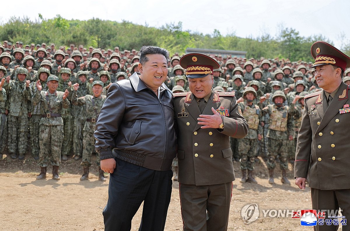 This photo, carried by North Korea's official Korean Central News Agency on May 14, 2025, shows the North's leader Kim Jong-un (L) supervising combined tactical drills of special operations the previous day. (For Use Only in the Republic of Korea. No Redistribution) (Yonhap)